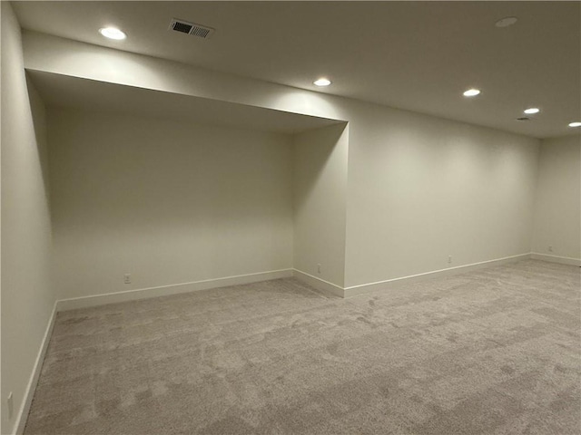 basement featuring light colored carpet