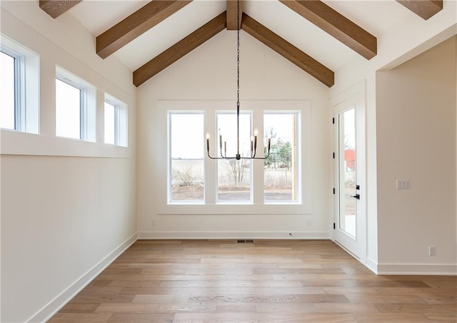 unfurnished dining area featuring vaulted ceiling with beams, a chandelier, and light hardwood / wood-style flooring