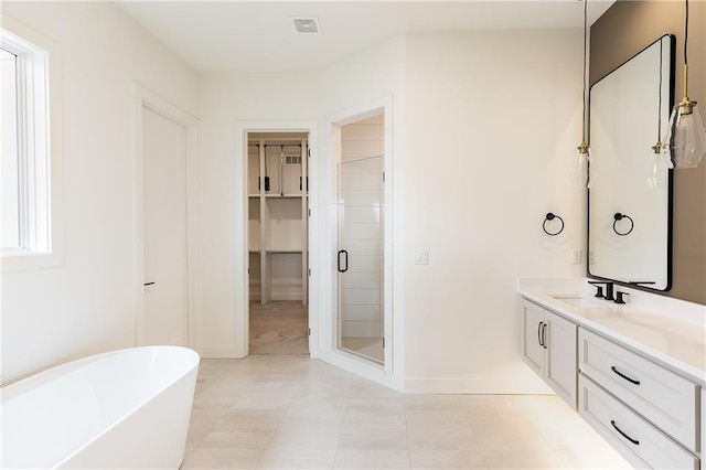 bathroom with vanity and independent shower and bath