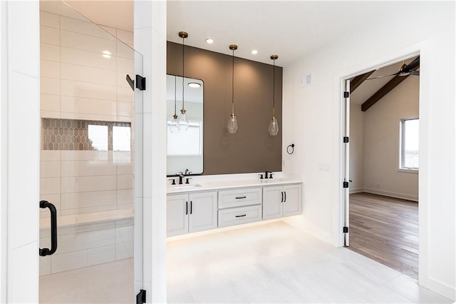 bathroom with vanity, a shower with door, and vaulted ceiling with beams