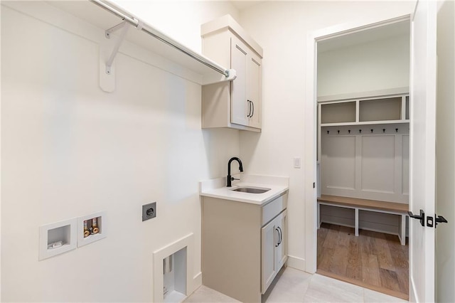 clothes washing area with washer hookup, sink, cabinets, and hookup for an electric dryer