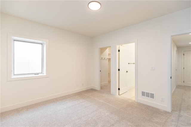 unfurnished bedroom featuring light carpet