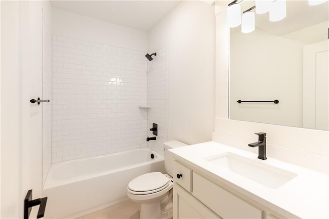 full bathroom with vanity, tiled shower / bath combo, and toilet