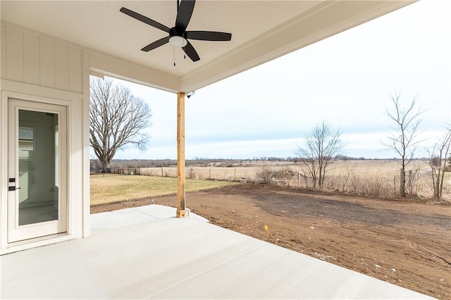 view of patio featuring ceiling fan and a rural view