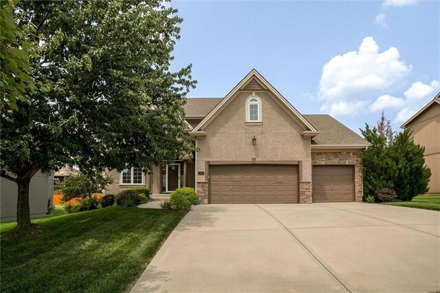 view of front of house with a garage and a front yard