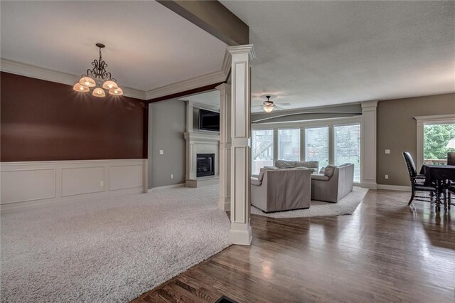 dining area featuring ornate columns, ornamental molding, hardwood / wood-style flooring, and ceiling fan with notable chandelier