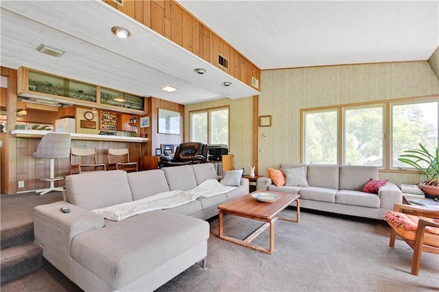 living room with a wealth of natural light and carpet flooring