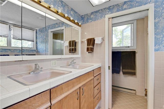 bathroom with vanity, tile walls, and a baseboard heating unit