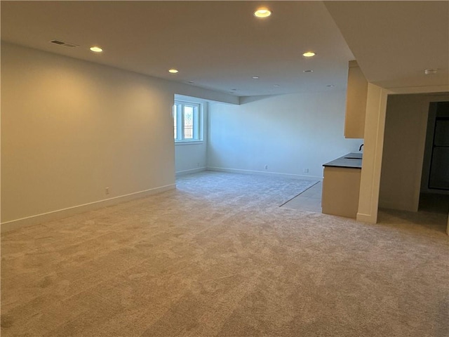 unfurnished living room with baseboards, recessed lighting, visible vents, and light colored carpet