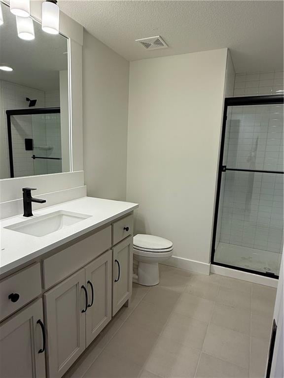 full bath featuring a stall shower, visible vents, vanity, and toilet