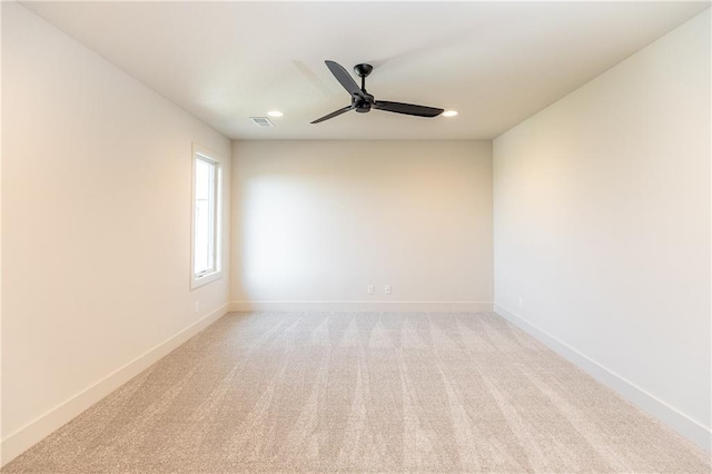 spare room with recessed lighting, baseboards, ceiling fan, and light colored carpet