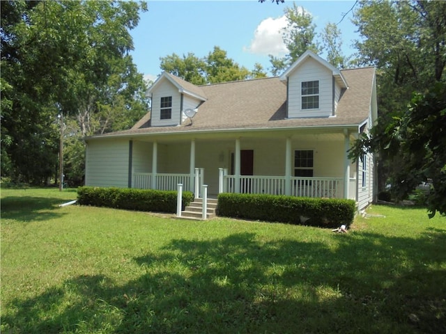 cape cod house featuring a porch and a front yard