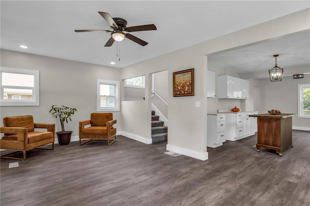 sitting room featuring ceiling fan and dark hardwood / wood-style flooring