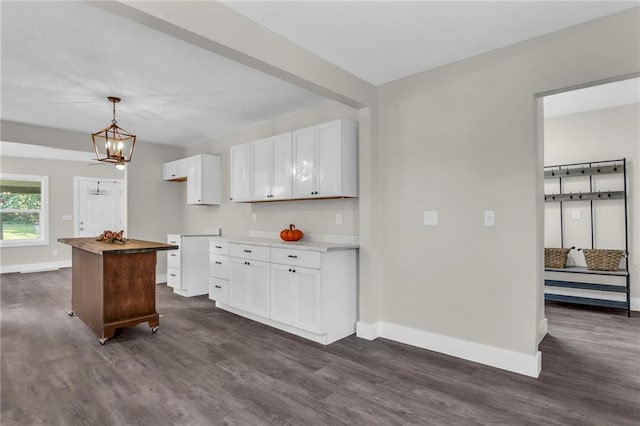 kitchen featuring dark hardwood / wood-style flooring, a center island, and white cabinets