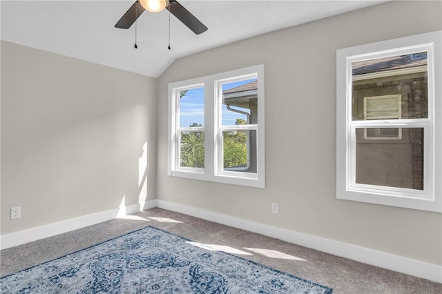 carpeted empty room with ceiling fan and vaulted ceiling