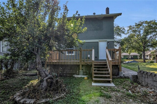 back of house featuring a yard and a deck