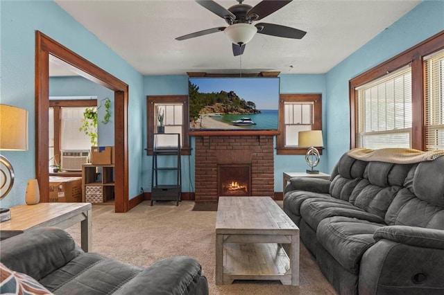 living room featuring cooling unit, a fireplace, ceiling fan, and carpet flooring