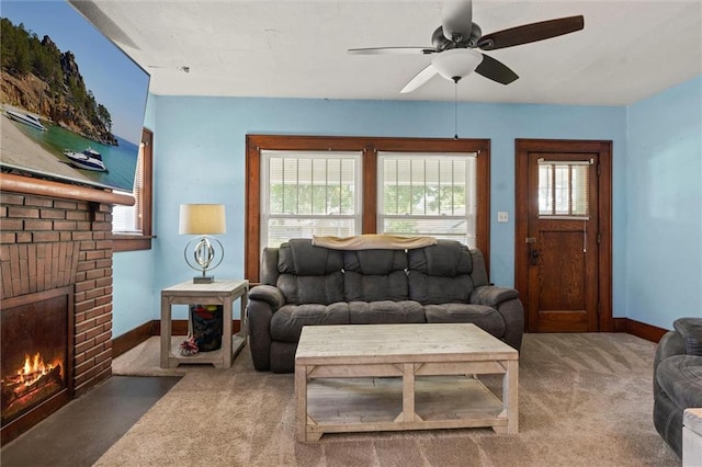 carpeted living room featuring a brick fireplace and ceiling fan