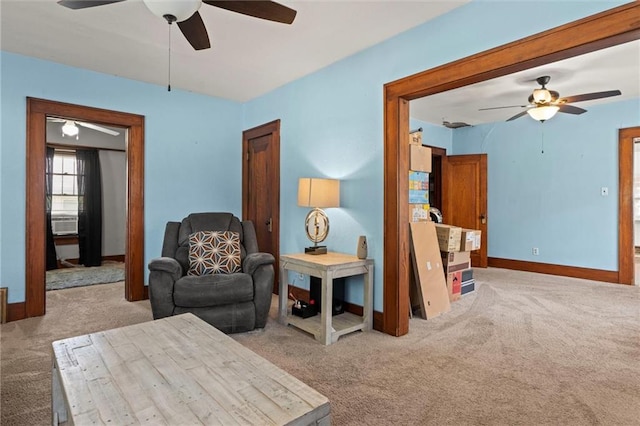 sitting room featuring light carpet and ceiling fan