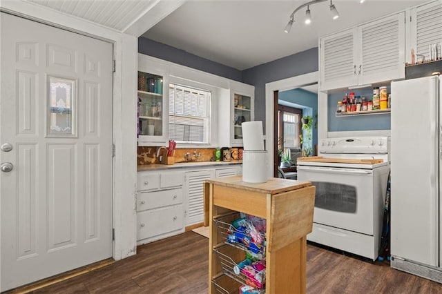 kitchen featuring white cabinetry, rail lighting, white appliances, sink, and dark wood-type flooring