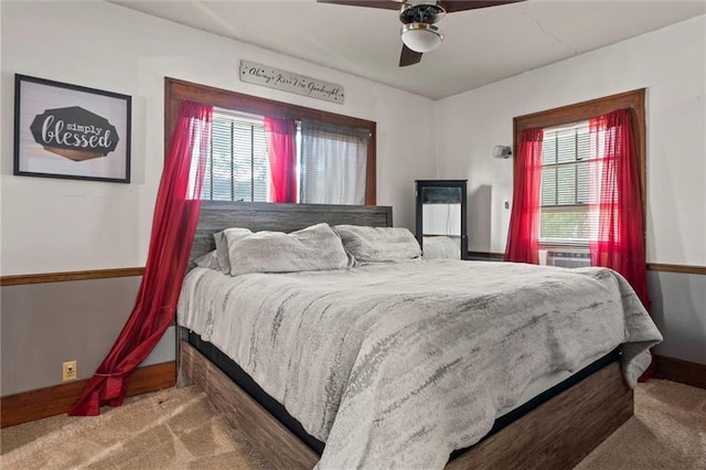 bedroom featuring multiple windows, ceiling fan, and carpet flooring