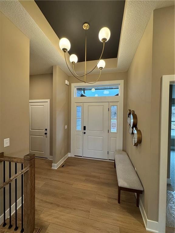 entrance foyer featuring light hardwood / wood-style floors and a textured ceiling