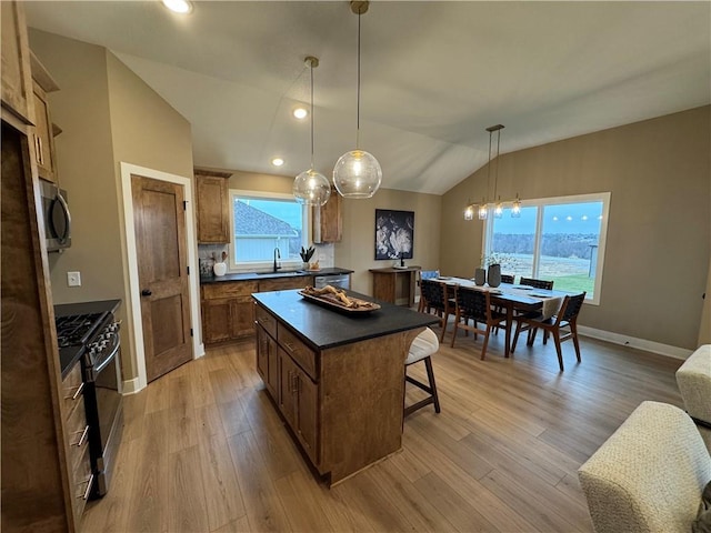 16700 NW 124th St, Platte City, MO 64079 - kitchen featuring stainless steel appliances, a kitchen island, a healthy amount of sunlight, and light wood-type flooring
