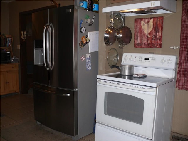 kitchen featuring stainless steel fridge, white electric stove, and light tile patterned floors