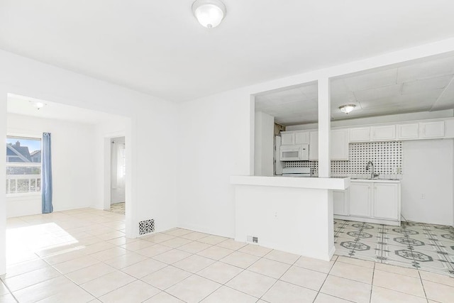 interior space featuring sink and light tile patterned floors