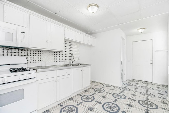 kitchen featuring decorative backsplash, white cabinetry, white appliances, and sink