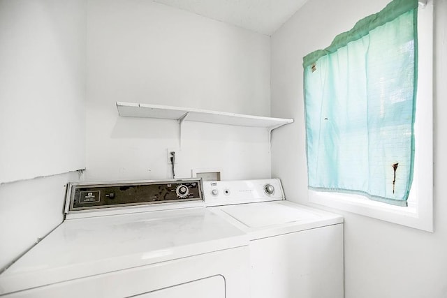 laundry room with washing machine and clothes dryer