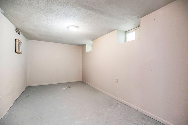 basement featuring a textured ceiling