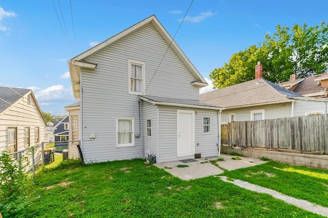 rear view of property featuring a yard