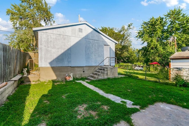 view of outbuilding featuring a lawn