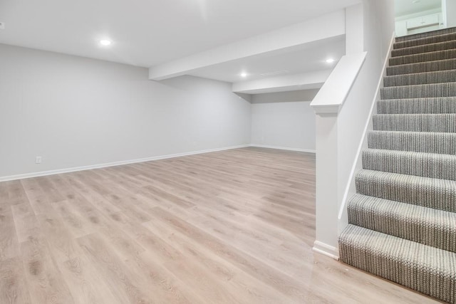 basement with light hardwood / wood-style flooring