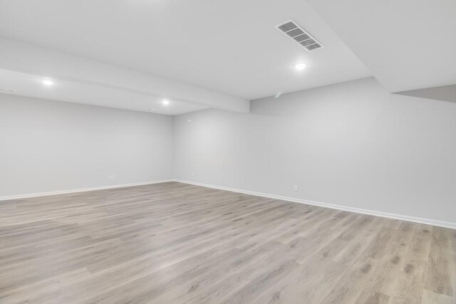 basement with light hardwood / wood-style flooring