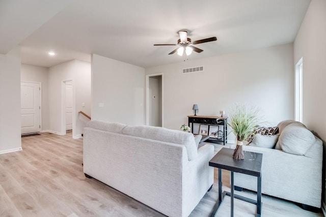 living room with ceiling fan and light wood-type flooring