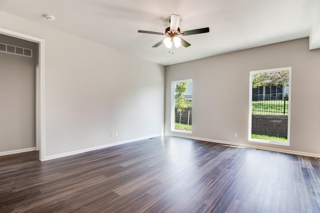 spare room with ceiling fan and dark hardwood / wood-style floors