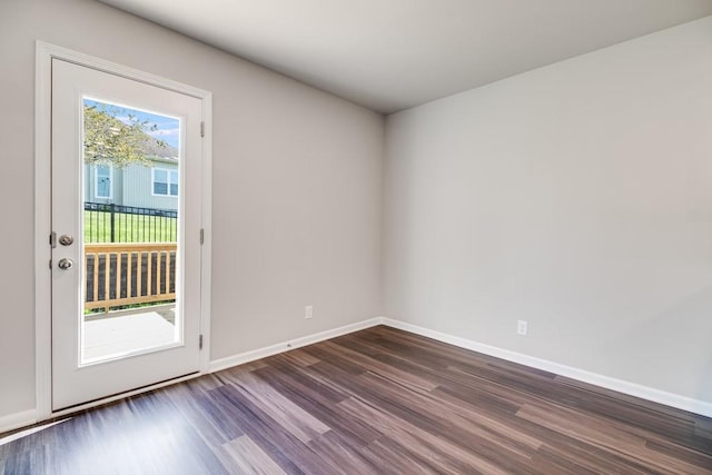 spare room with dark hardwood / wood-style floors