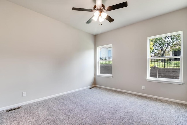 spare room with carpet and ceiling fan