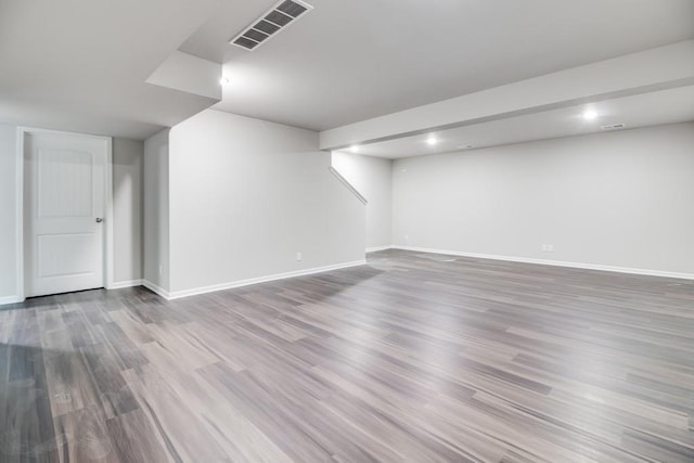 basement with hardwood / wood-style floors