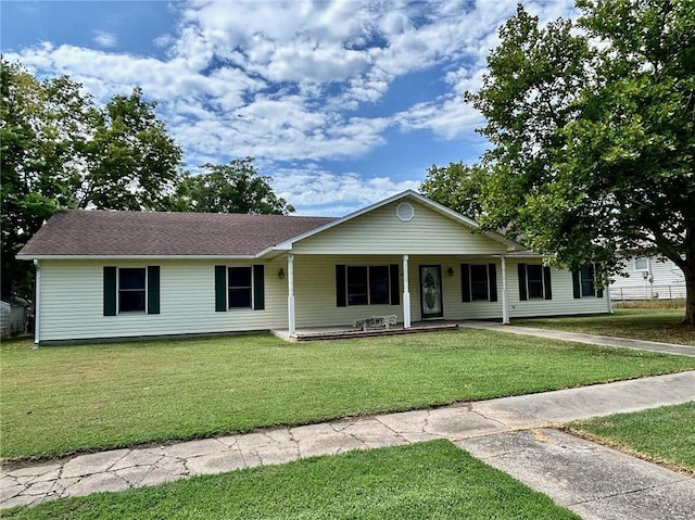 ranch-style house featuring a porch, a front yard, and a shingled roof