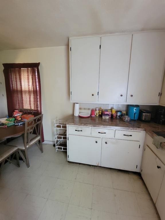 kitchen featuring sink and white cabinets