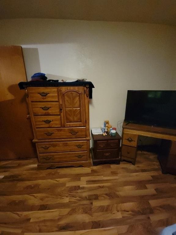 bedroom with dark wood-type flooring