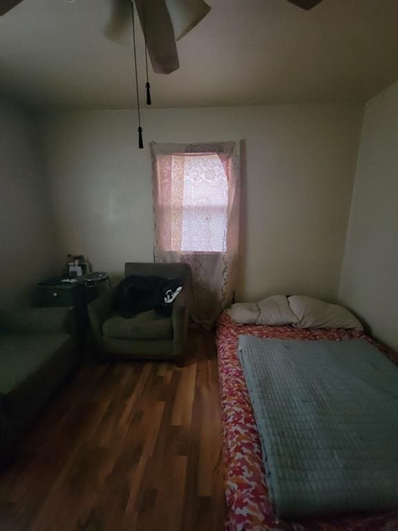 bedroom with dark wood-type flooring and ceiling fan