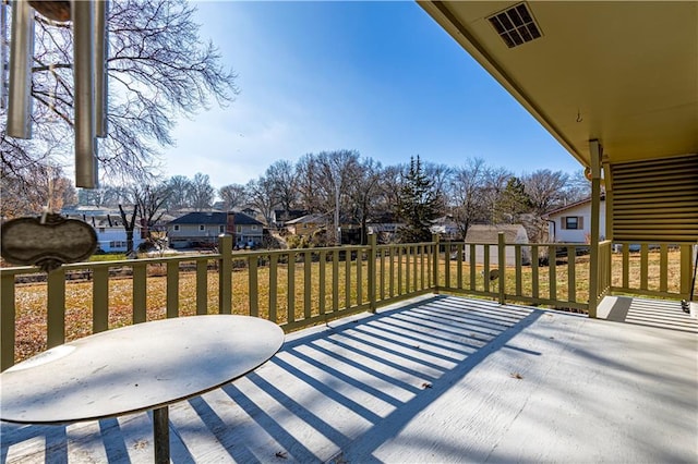 wooden terrace featuring a yard