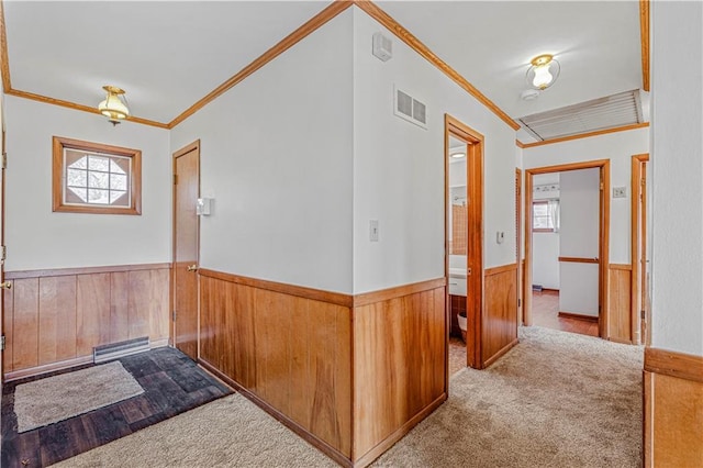 hallway with carpet floors and ornamental molding