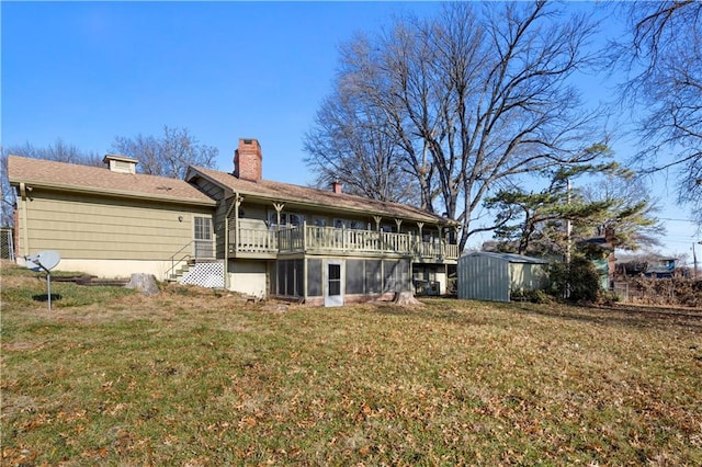 back of house with a yard and a shed