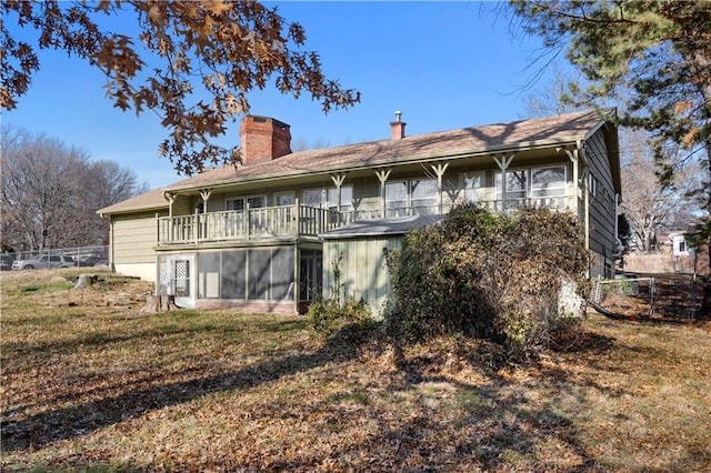 rear view of house featuring a lawn