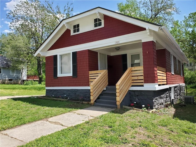 bungalow with central AC and a front yard